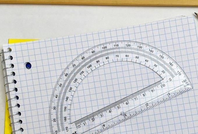 Squared spiral notebook with a protractor on top