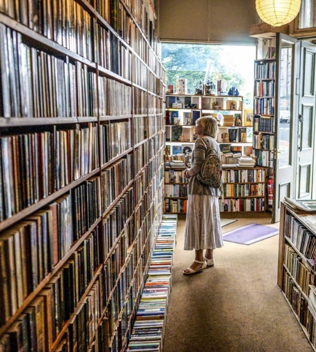 A bookshop aisle lined with full shelves