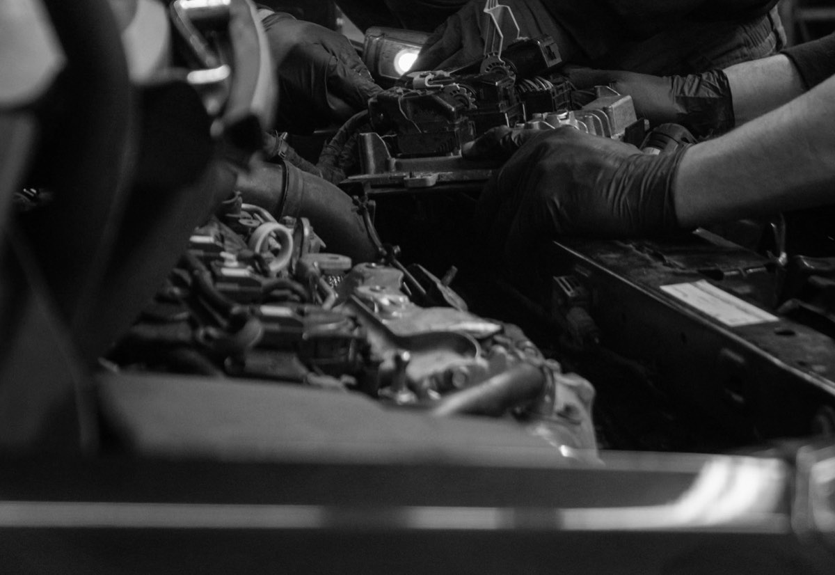 Gloved hands checking the engine connectors